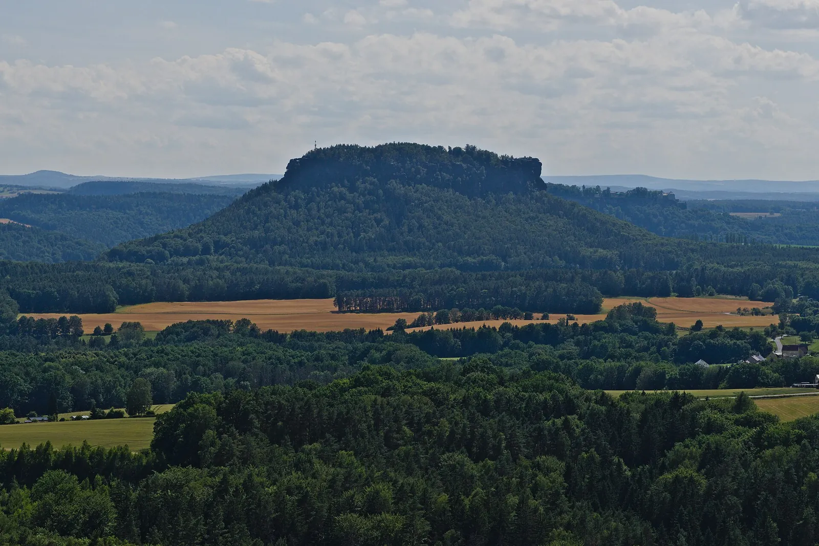 View from the Brand viewpoint in Saxon Switzerland National Park over forests and fields to the Lilienstein table mountain