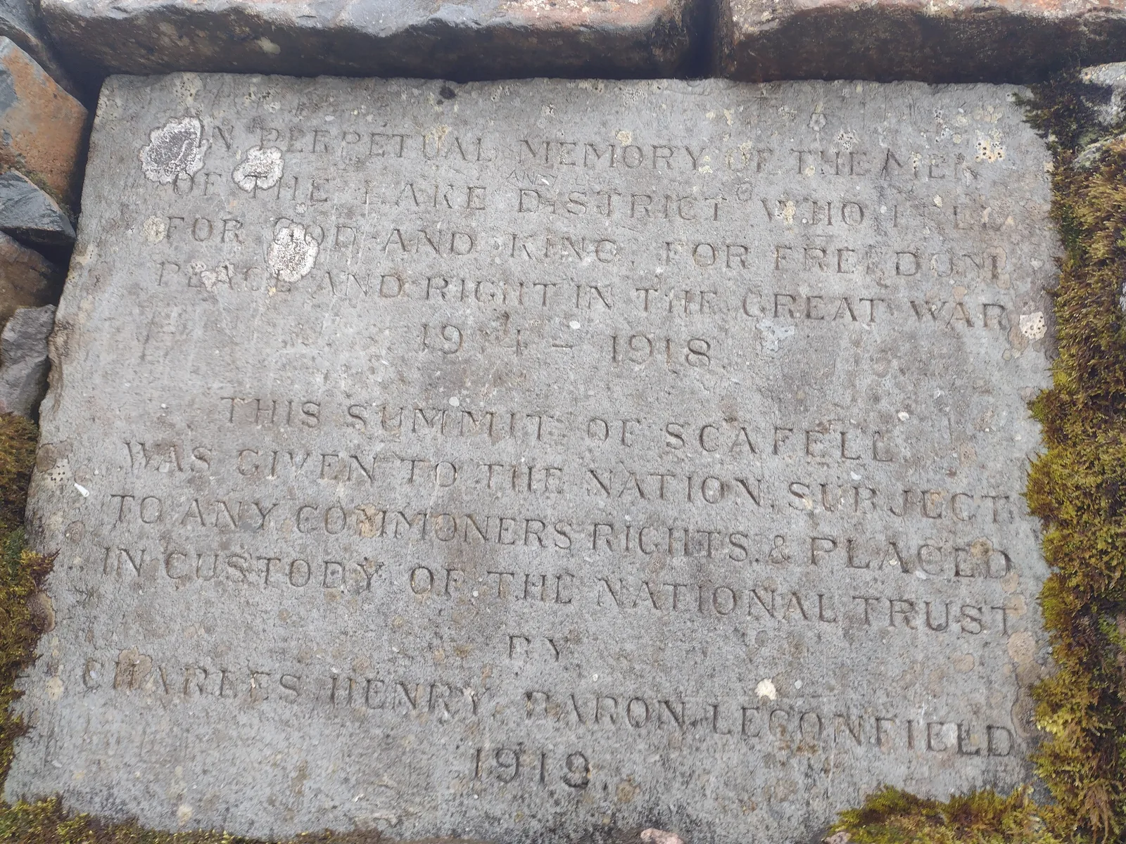 The 1919 memorial plaque in the summit cairn of Scafell Pike in the Lake District National Park