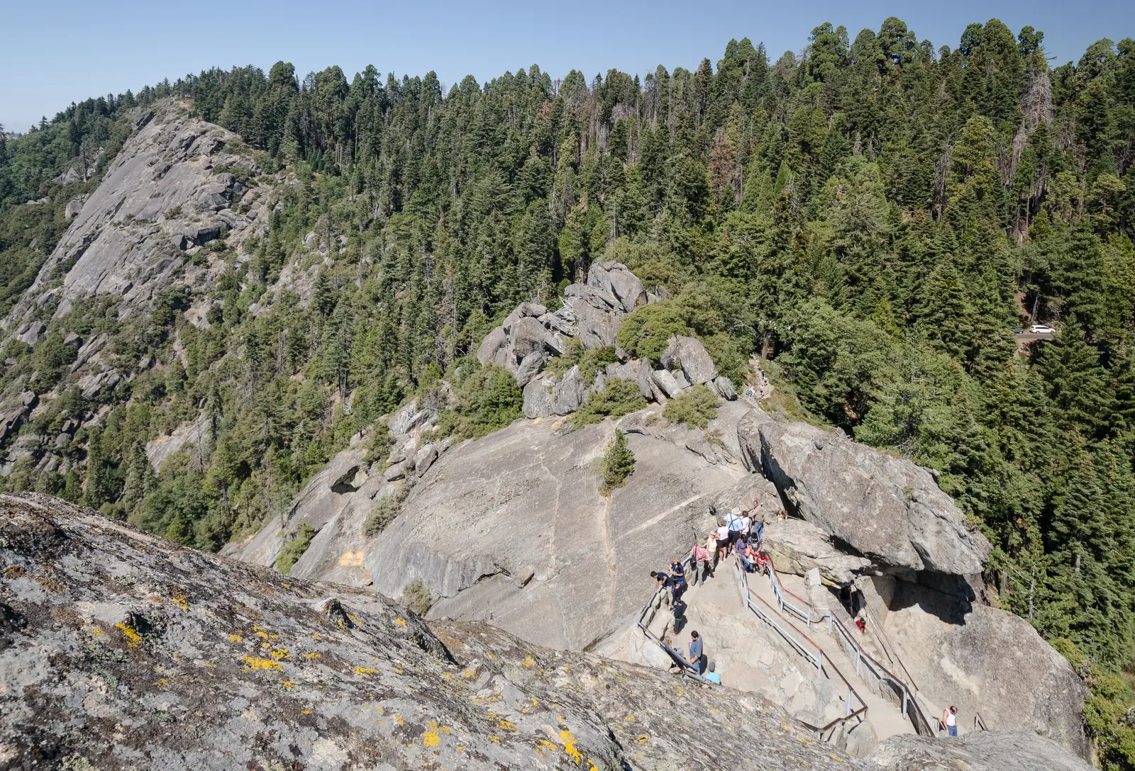 Steep staircase with railings on the granite dome of Moro Rock in Sequoia National Park, with visitors on it