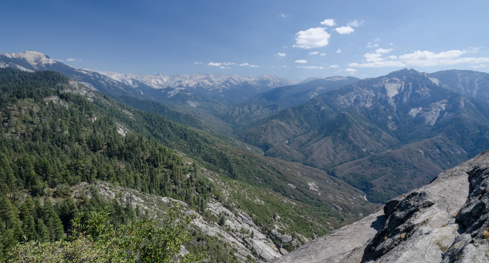 View from Moro Rock in Sequoia National Park over forested valleys to the peaks of the Great Western Divide