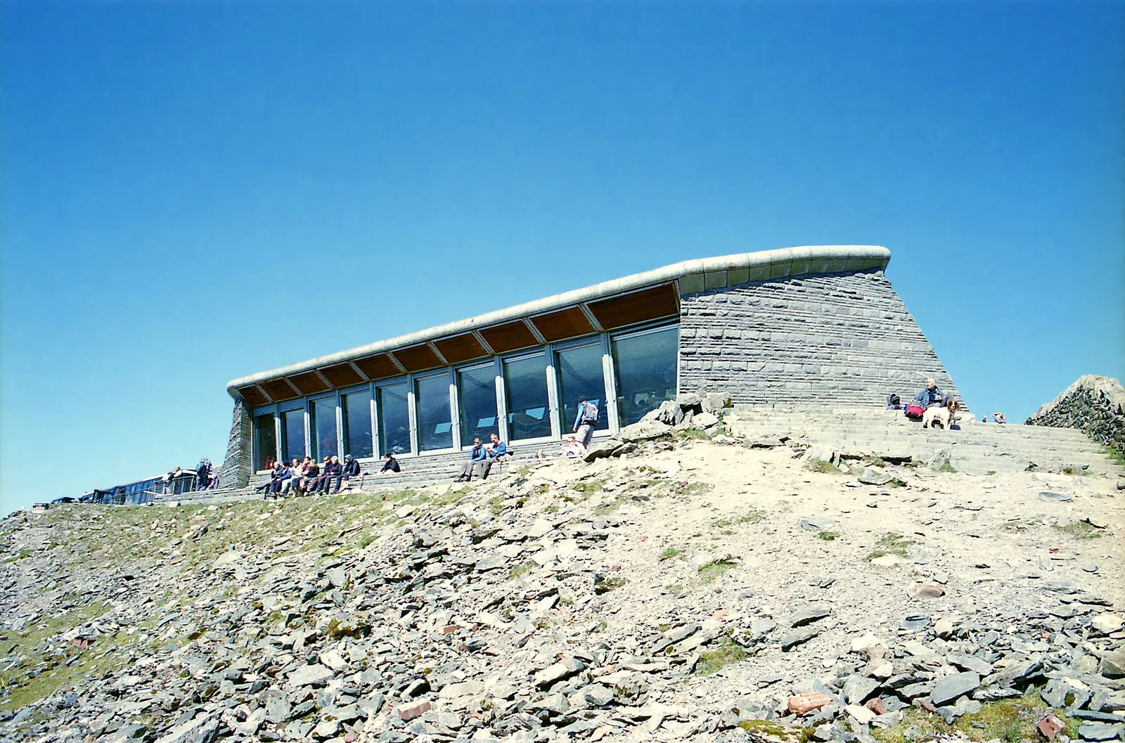 The summit building Hafod Eryri on Snowdon in Snowdonia National Park with its large glass front, walkers outside