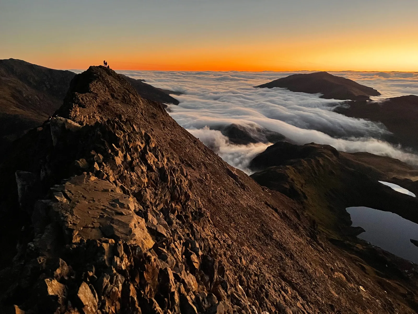 Sunrise over a sea of cloud on the Crib Goch ridge in Snowdonia National Park