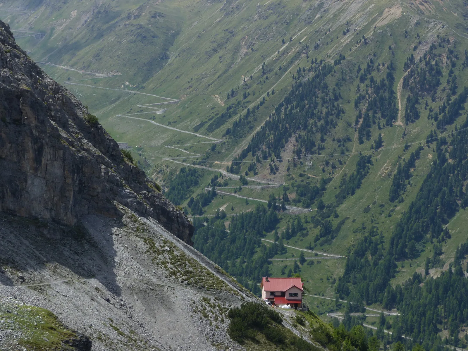 The hairpins of the Stelvio Pass road winding through the valley below the Berglhütte in Stelvio National Park