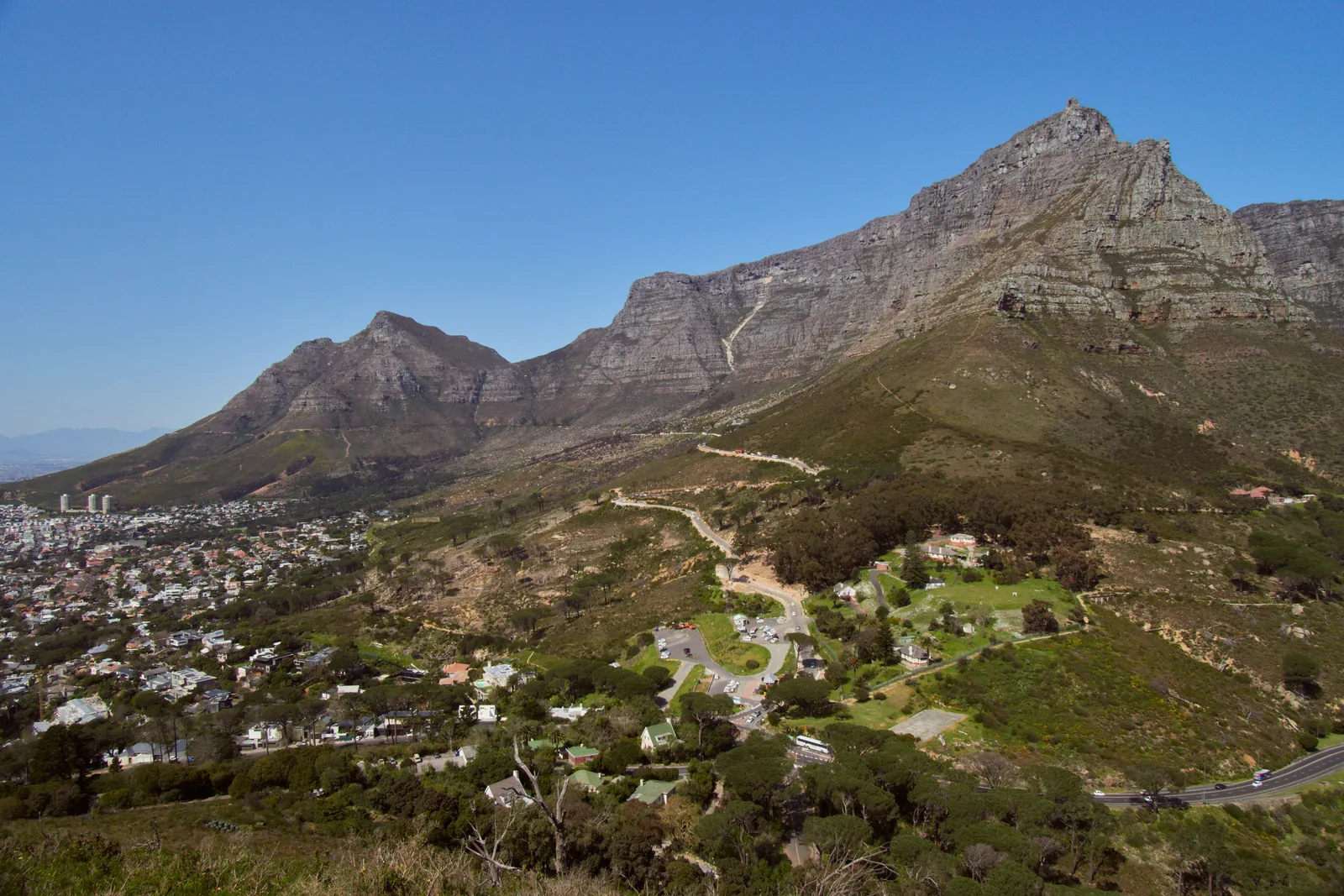 View from Lion’s Head of Table Mountain and Devil’s Peak, with the houses of Cape Town and the road to Kloof Nek below