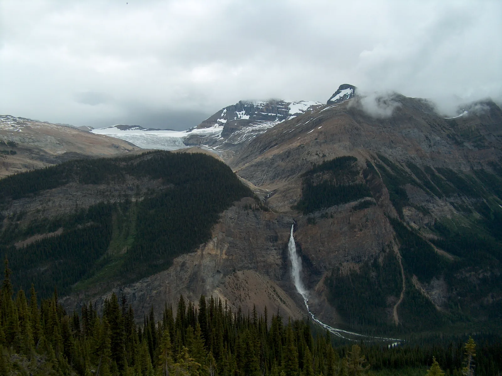 View from the Iceline of Takakkaw Falls in Yoho National Park, with the Daly Glacier above under clouds.