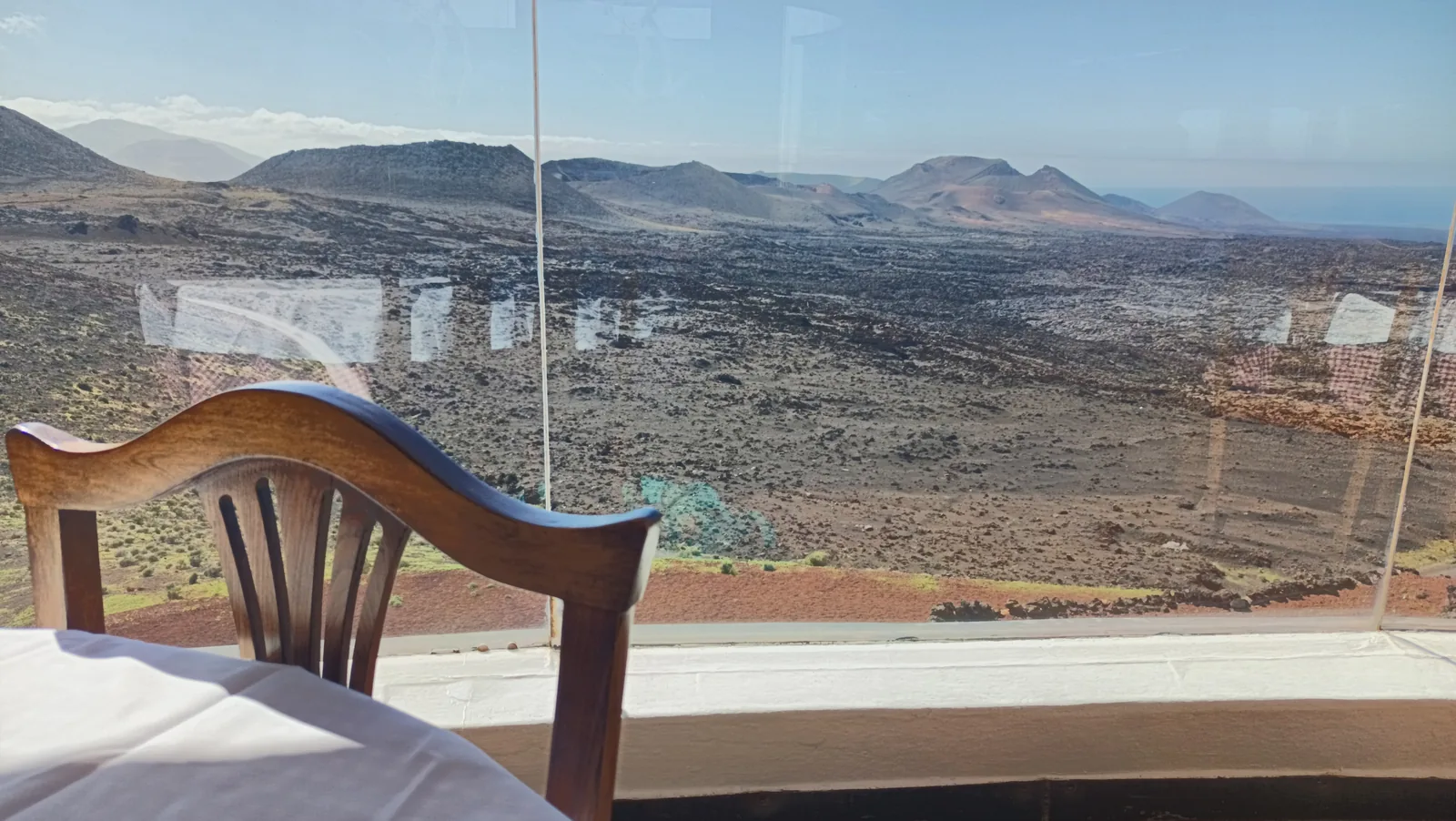 The round grill of the El Diablo restaurant in Timanfaya National Park with chicken and sausages on the racks above the open shaft