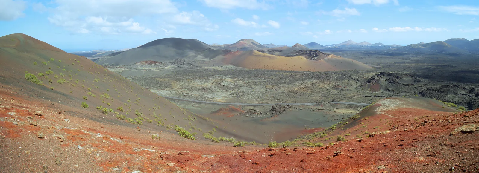 Panorama from the Ruta de los Volcanes in Timanfaya National Park: on the left the black cone of Montaña del Selado, on the right the red Caldera del Corazoncillo