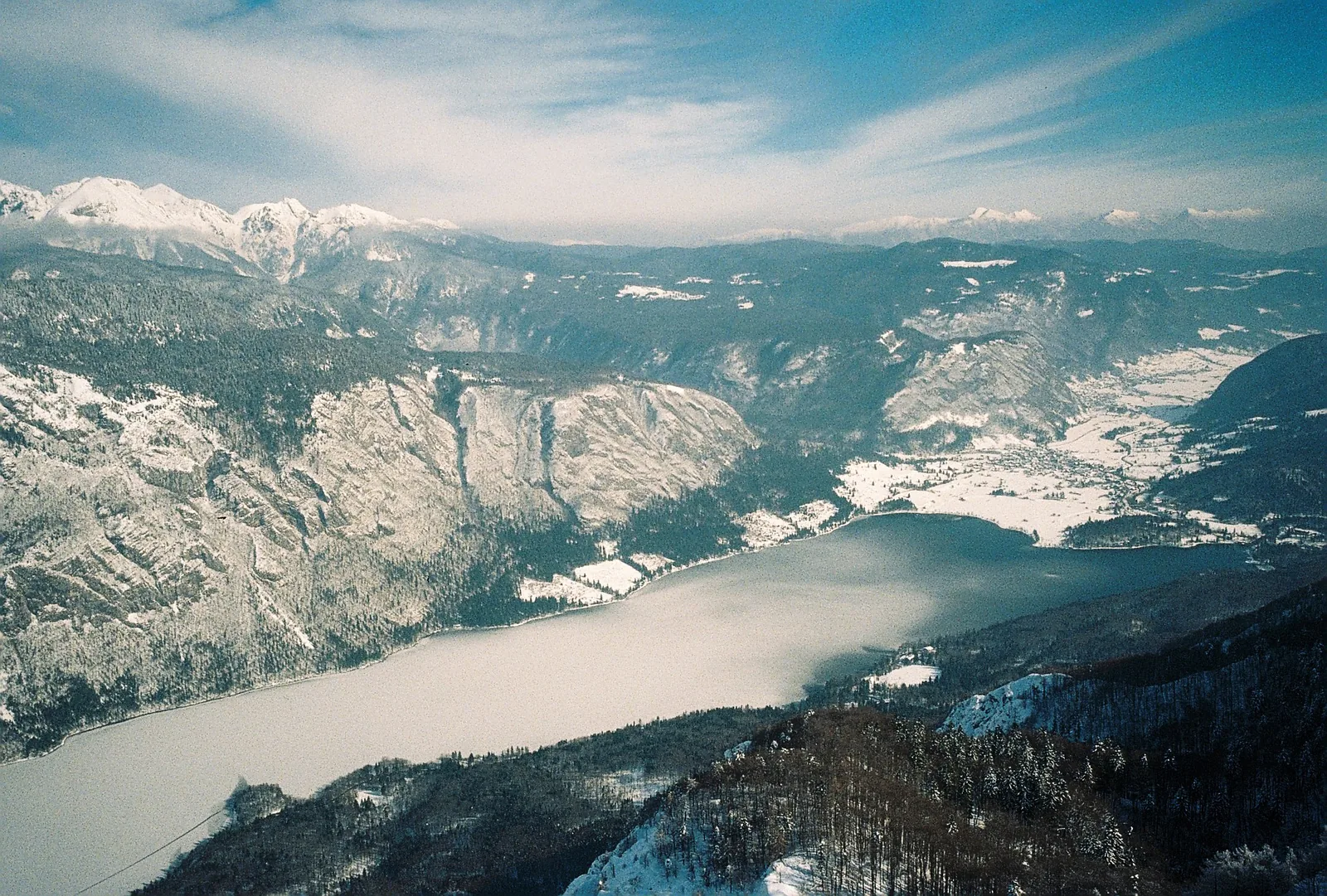 Lake Bohinj in Triglav National Park from above, with the snow-covered Julian Alps behind