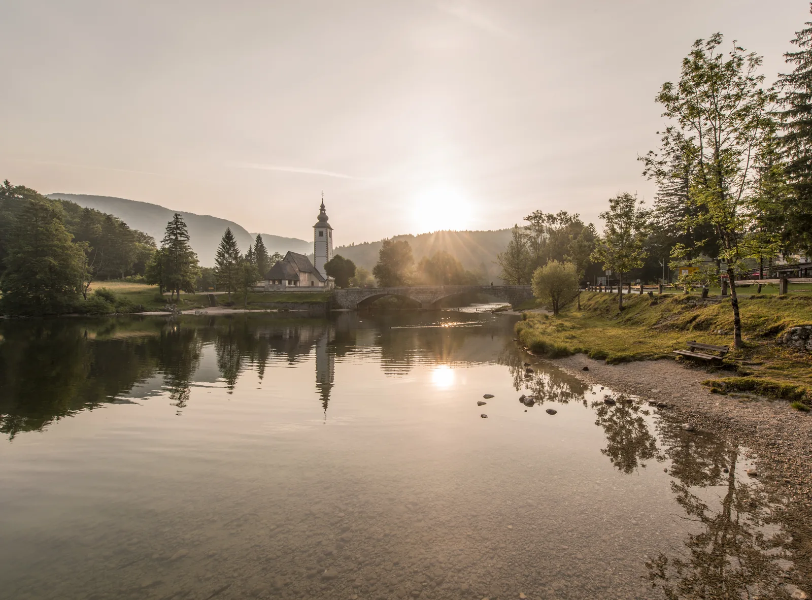 Morning on the eastern shore of Lake Bohinj in Triglav National Park, with the Church of St John the Baptist and the stone bridge