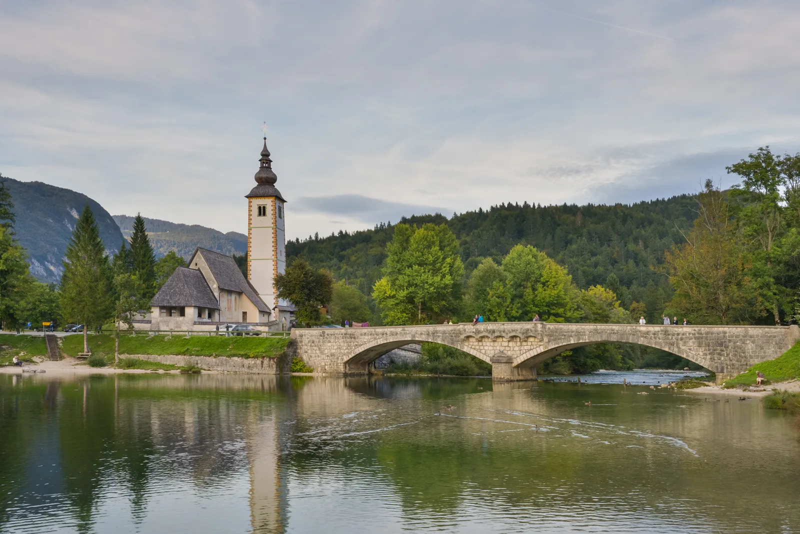 The Church of St John the Baptist and the stone bridge at Ribčev Laz on the eastern shore of Lake Bohinj in Triglav National Park