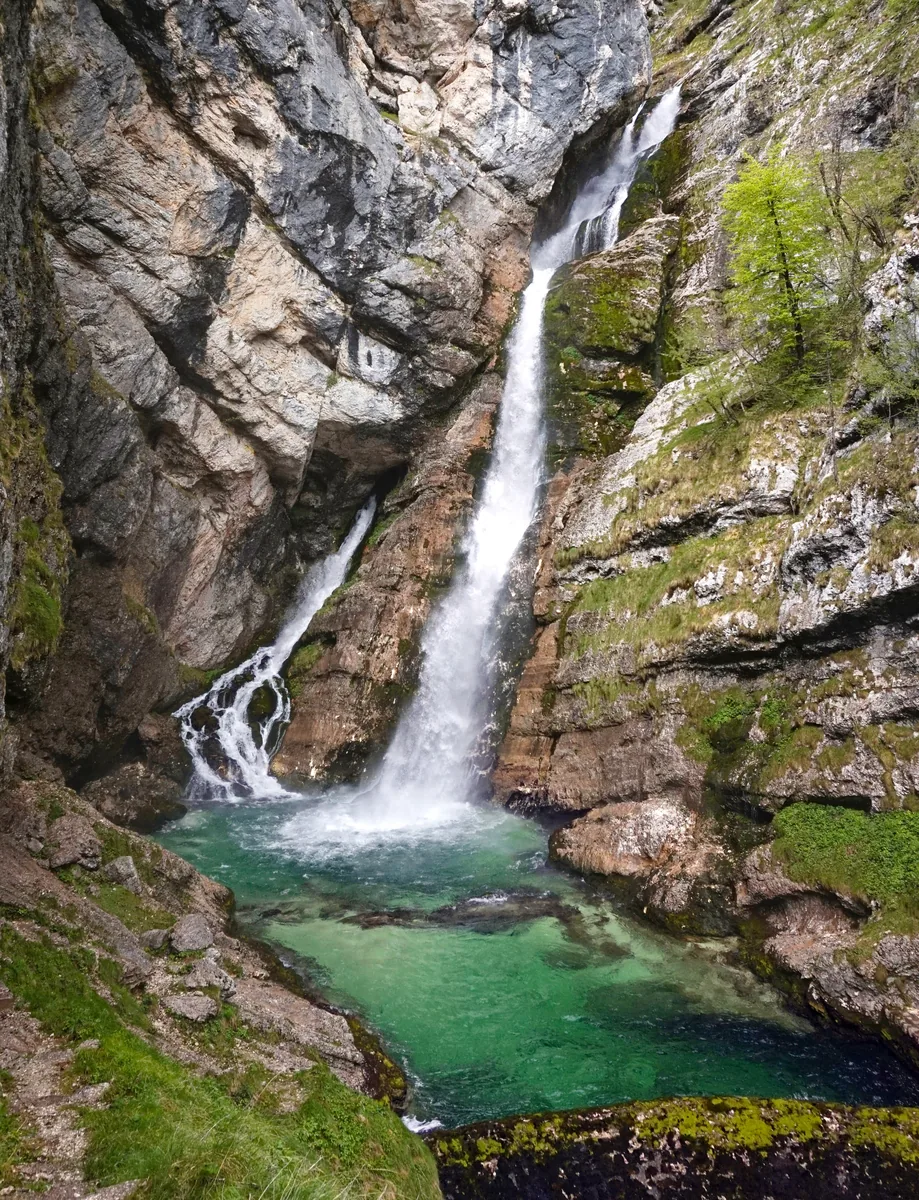 Savica Waterfall in Triglav National Park plunges from a rock face into a green pool
