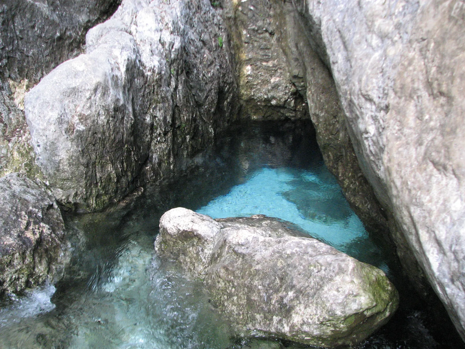 The source of the Soča in Triglav National Park: clear, turquoise water emerging between pale rocks