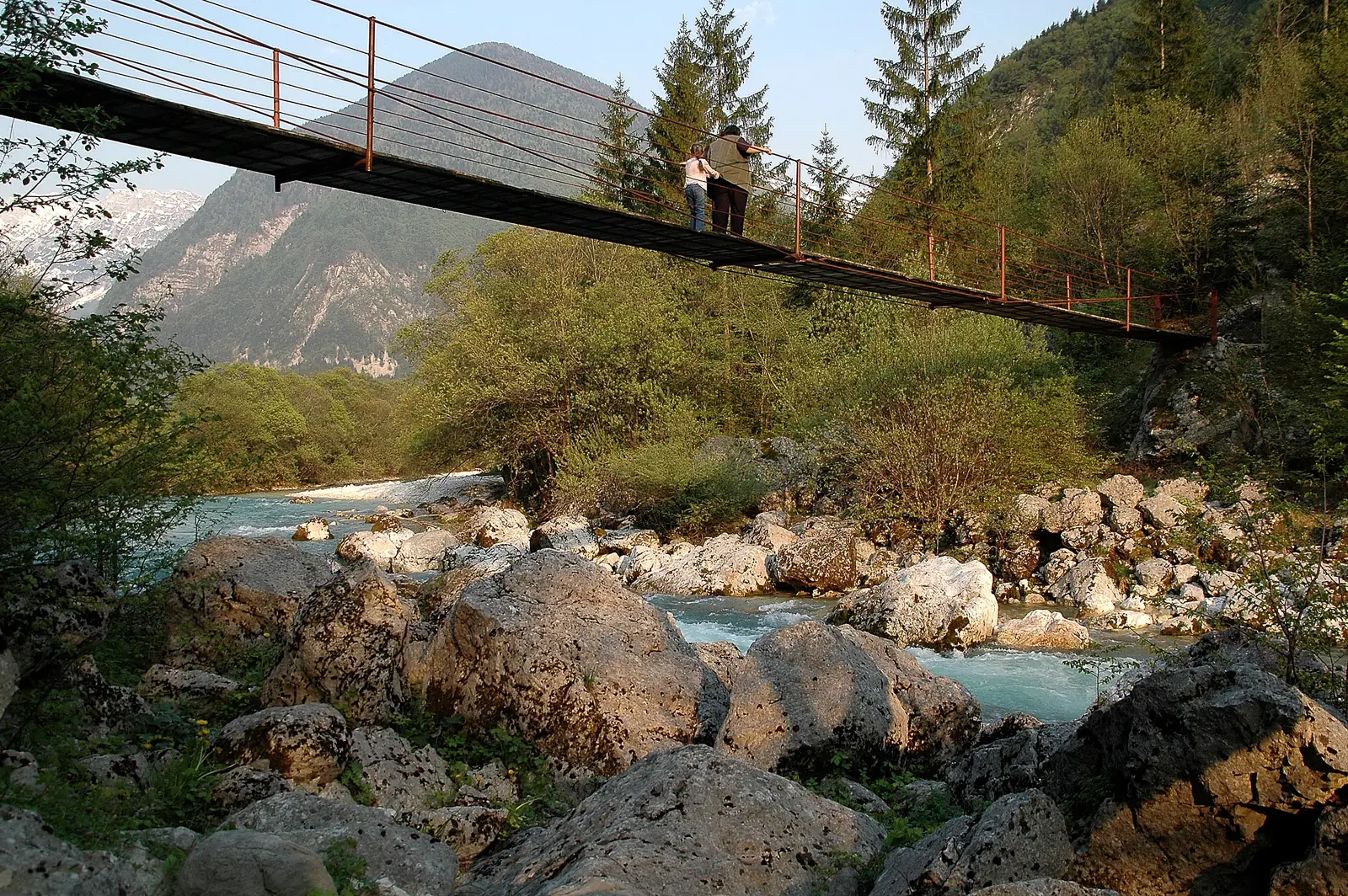 Suspension bridge over the Soča in the lower Trenta in Triglav National Park, with the clear river below