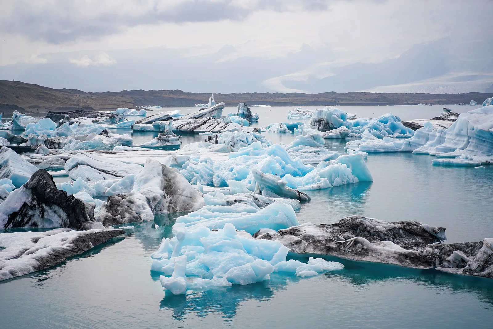Icebergs with blue and white faces float on Jökulsárlón in Vatnajökull National Park