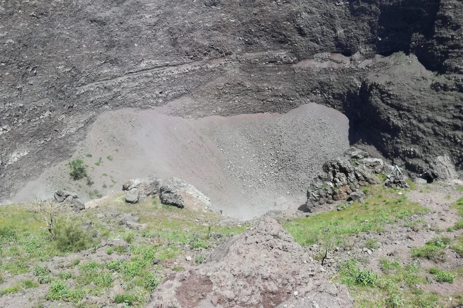 View into the crater of Vesuvius in Vesuvius National Park, with scree slopes and dark lava walls
