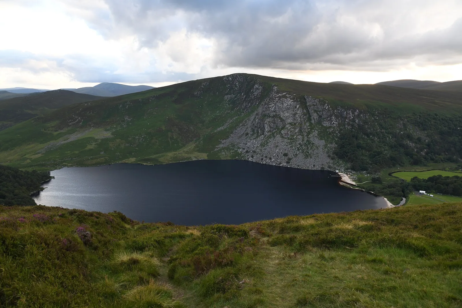 Lough Tay in the Wicklow Mountains, a dark lake beneath steep brown slopes