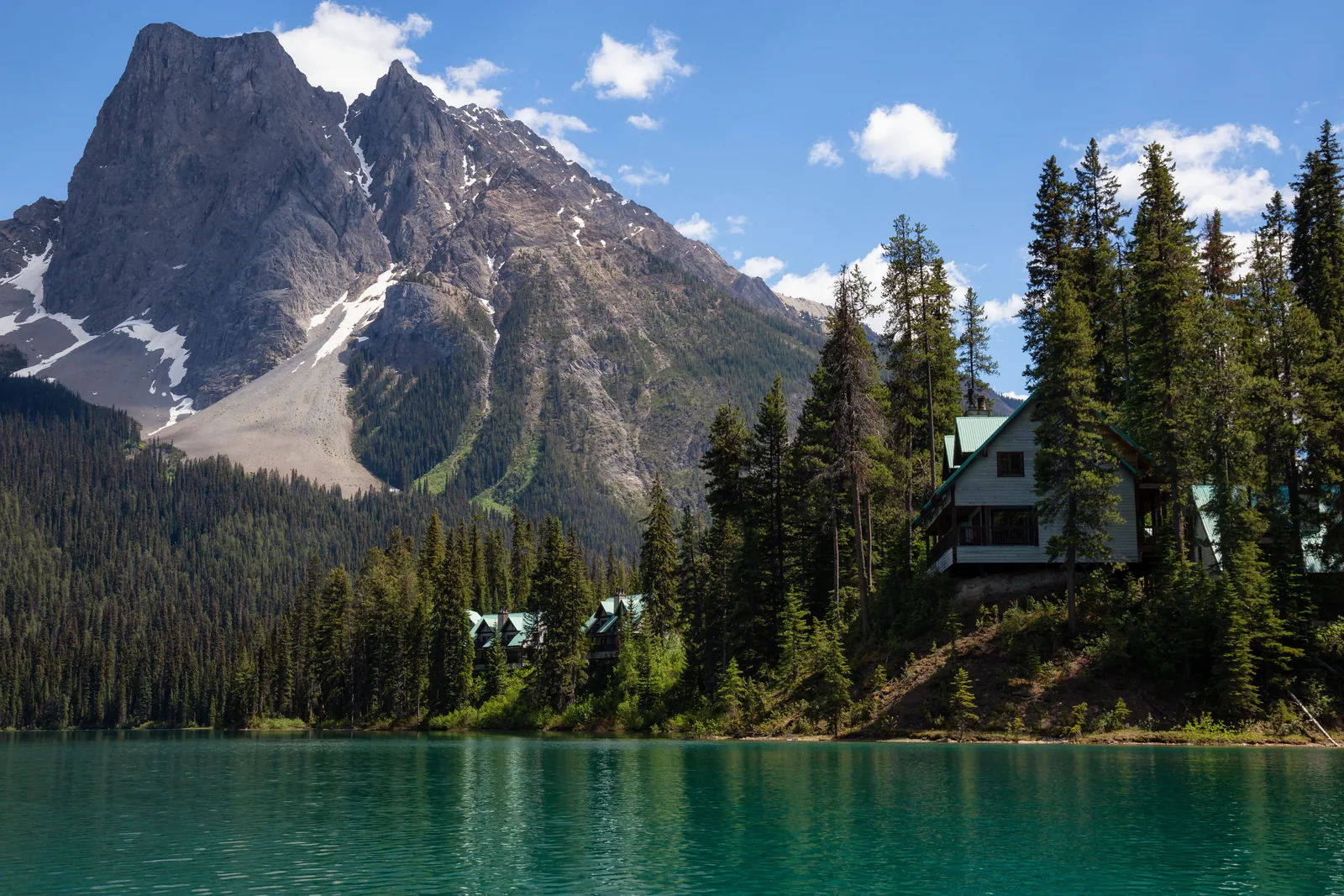 Emerald Lake in Yoho National Park with the lodge on the forested shore below rugged mountains